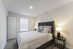 Kansas City apartment for rent - Kansas City, MO, Pet-Friendly Villas - Barry West - Bedroom With Upholstered Bed, White Bedding, Nightstands With Lamps, Neutral Walls, And A Window.