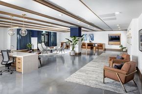 Huntsville apartment for rent - A modern office space with a mix of seating options and a clean, open design.