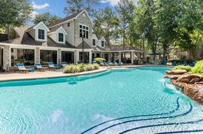 Woodlands apartment for rent - A large house with a pool in front.