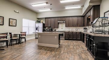 Fort Worth apartment for rent - A kitchen with wooden floors and a large island in the middle.