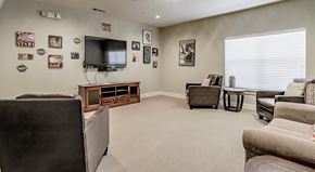 Fort Worth apartment for rent - A living room with a television, a couch, and a chair.