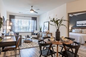 Greensboro apartment for rent - A dining room with a table set for two and a bed in the background.