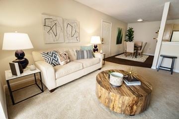 Kernersville apartment for rent - A living room with a white couch and a wooden coffee table.