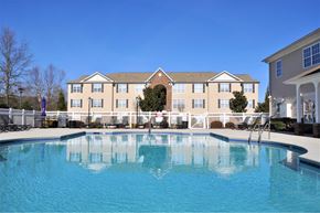 High Point apartment for rent - A large building with a pool in front of it.