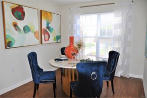 High Point apartment for rent - A dining room with a white table and blue chairs.