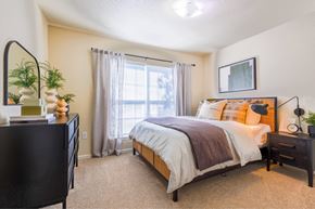 Hattiesburg apartment for rent - A bedroom with a large bed and a dresser.