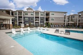 Greensboro apartment for rent - A swimming pool in front of apartment buildings.