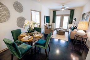 Greensboro apartment for rent - A dining room with a table set for two and green chairs.