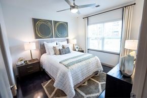 Greensboro apartment for rent - A bedroom with a bed, nightstands, and a ceiling fan.