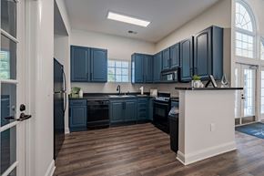 Goldsboro apartment for rent - A kitchen with dark blue cabinets and a white island.
