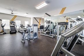 Fayetteville apartment for rent - A gym with a variety of equipment including treadmills, weights, and exercise machines.