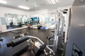 New Bern apartment for rent - A gym with a variety of equipment including a treadmill, a weight machine and a rowing machine.
