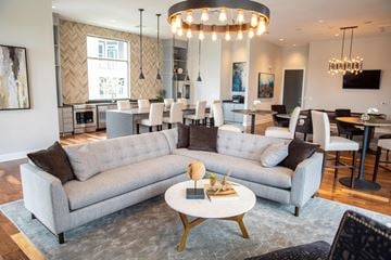 Huntersville apartment for rent - A modern living room with a grey sofa set and a chandelier.