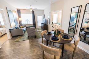 Fort Mill apartment for rent - A dining room with a table set for two and a couch.
