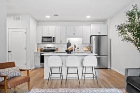 St. Louis Park apartment for rent - A kitchen with white cabinets and a refrigerator.