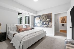St. Louis Park apartment for rent - A bedroom with a large bed and a painting on the wall.