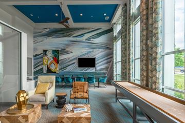 Dallas apartment for rent - A living room with a blue ceiling and a large painting on the wall.