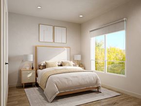 Parsippany apartment for rent - A bedroom with a large bed and a window overlooking a tree.