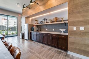 North Richland Hills apartment for rent - A modern kitchen with wooden cabinets and a large island.