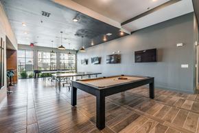 North Richland Hills apartment for rent - A room with a pool table and a bar area.