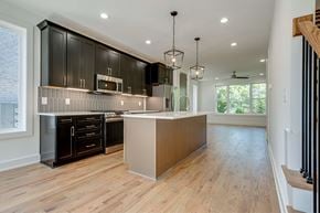 Nashville townhouse for rent - A kitchen with black cabinets and a wooden island.