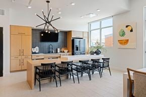Kansas City apartment for rent - A modern kitchen with a dining table set for six.