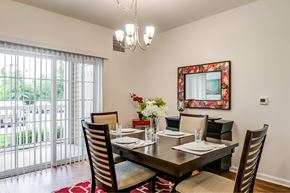 Mount Laurel apartment for rent - A dining room with a table set for two and a chandelier hanging from the ceiling.
