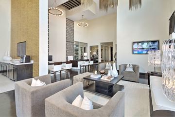 Houston apartment for rent - A modern living room with a grey sofa and a television.