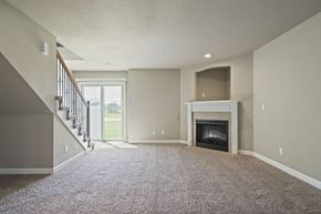 Peculiar apartment for rent - A living room with a fireplace and a staircase.