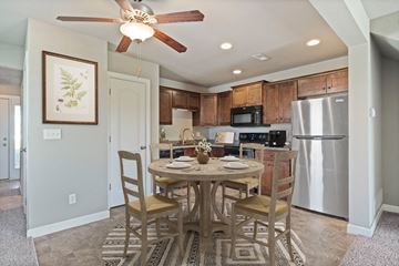 Peculiar apartment for rent - A kitchen with a table and chairs in the middle of the room.