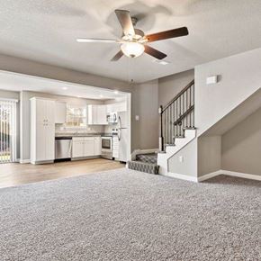 Belton apartment for rent - A spacious living room with a staircase leading to the upper floor.