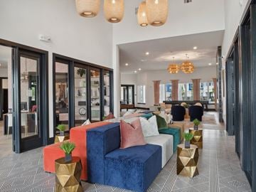 Katy apartment for rent - A modern living room with a blue sofa and gold vases.