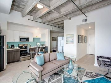 St. Petersburg apartment for rent - A modern living room with a glass coffee table and a couch.