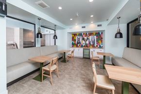 Austin apartment for rent - A modern dining area with wooden chairs and tables.