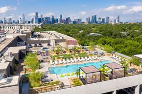 Austin apartment for rent - A rooftop pool area with Austin, TX skyline in the background.