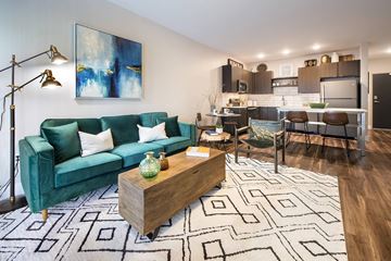 Kansas City apartment for rent - A living room with a green couch and a coffee table.