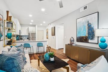 Dallas apartment for rent - A living room with a white couch and a painting on the wall.
