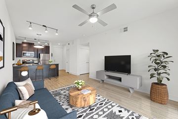 Austin apartment for rent - A living room with a blue couch and a television.
