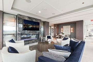 Portland apartment for rent - A modern living room with a fireplace and a large painting on the wall.