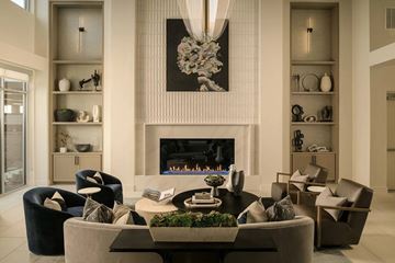 Richardson apartment for rent - A modern living room with a fireplace and a large painting above it.