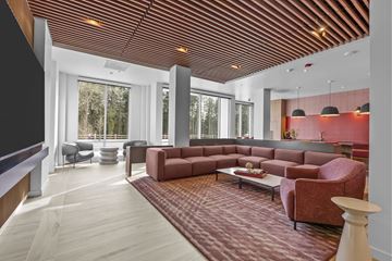 Hillsboro apartment for rent - A living room with a red carpet and a wooden ceiling.