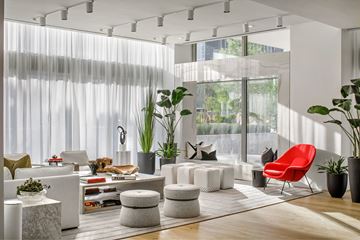 Dallas apartment for rent - A modern living room with a red chair and white furniture.