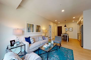 St Paul apartment for rent - A living room with a white couch and a glass coffee table.