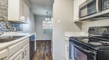 Bedford apartment for rent - A kitchen with a black stove top oven.