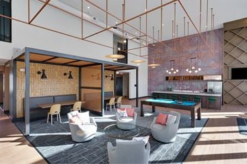 Jeffersonville apartment for rent - A modern living room with a pool table and a bar area.