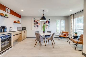 Garland apartment for rent - A modern kitchen with a dining table set for four.