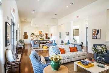 Buda apartment for rent - A living room with a blue couch and a green vase on a coffee table.
