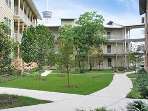 San Antonio apartment for rent - the courtyard of an apartment building with trees and a sidewalk