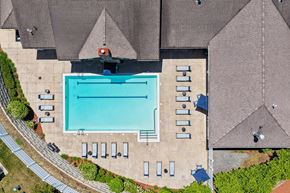 Methuen apartment for rent - An aerial view of a swimming pool surrounded by a parking lot.