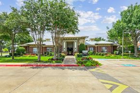 Grand Prairie apartment for rent - A building with a red and yellow painted crosswalk in front of it.